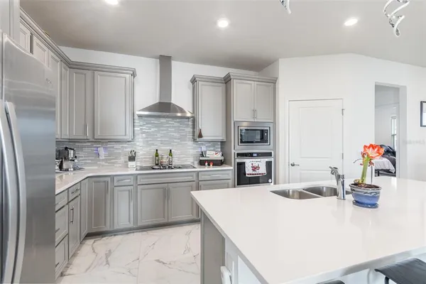 a kitchen with kitchen island a sink stove and refrigerator