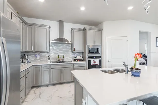 a kitchen with kitchen island a sink stove and refrigerator