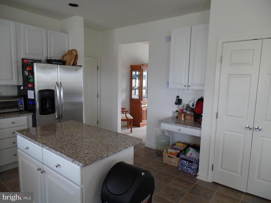 15 Wabash Road Inwood, WV 25428 - Photo 14 of 30 a kitchen with stainless steel appliances granite countertop a sink refrigerator and cabinets