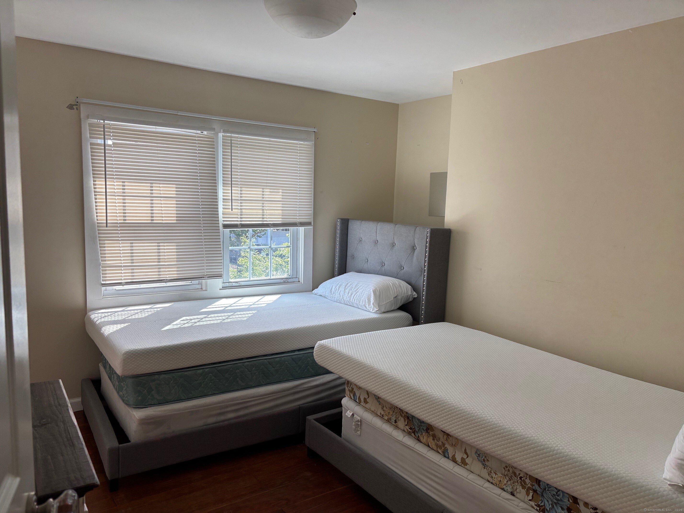 799 Rowland Road Fairfield, CT 06824 - Photo 12 of 15 a bedroom with a bed and windows