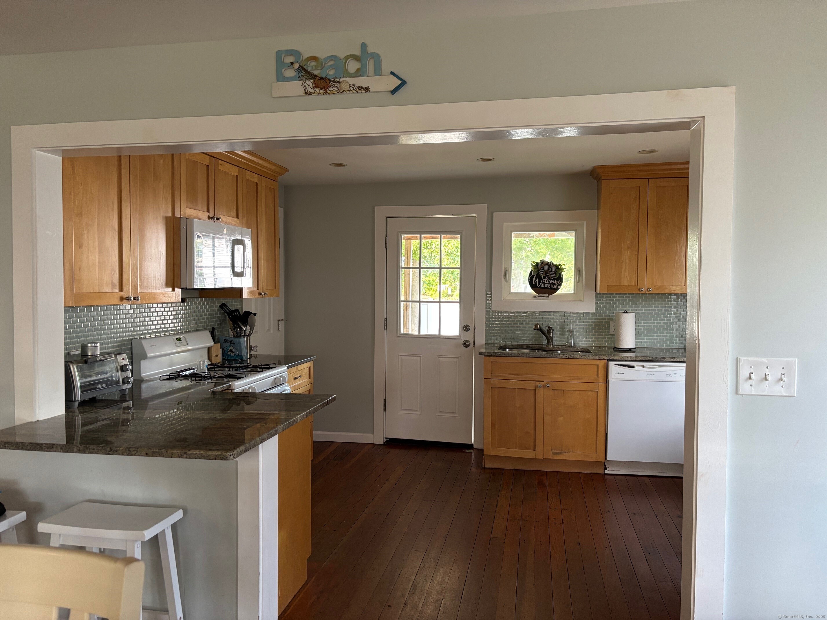 799 Rowland Road Fairfield, CT 06824 - Photo 5 of 15 a kitchen with a refrigerator and a stove top oven