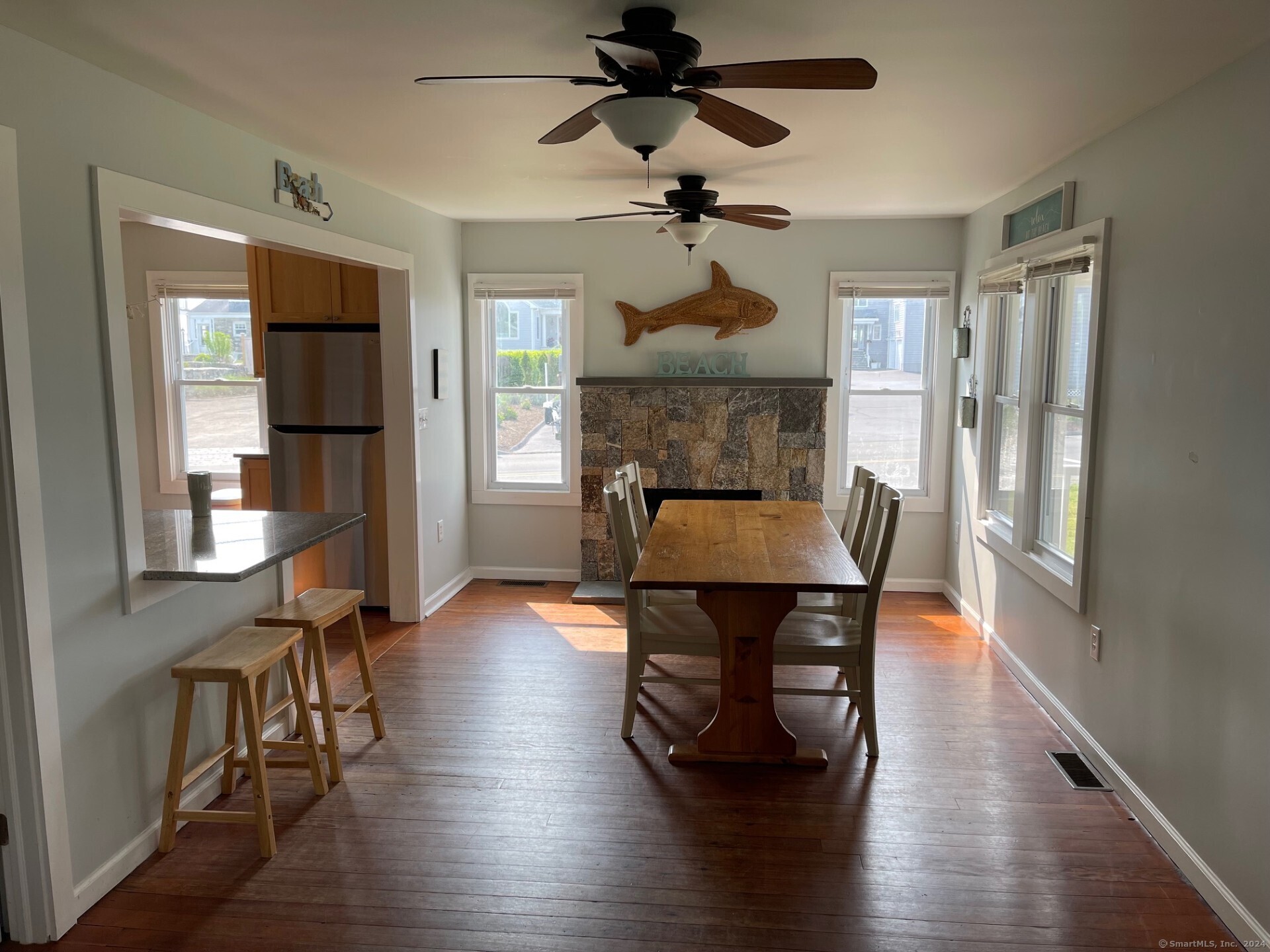 799 Rowland Road Fairfield, CT 06824 - Photo 7 of 15 a view of a dining room with furniture window and wooden floor