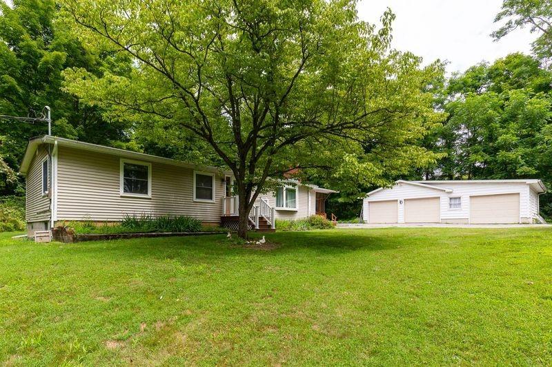 30 Barrytown Road Red Hook, NY 12571 - Photo 1 of 1 View of front of property featuring an outdoor structure, a garage, and a front lawn