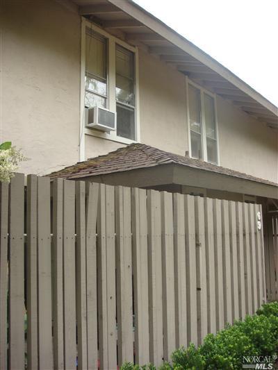 a front view of a house with wooden fence