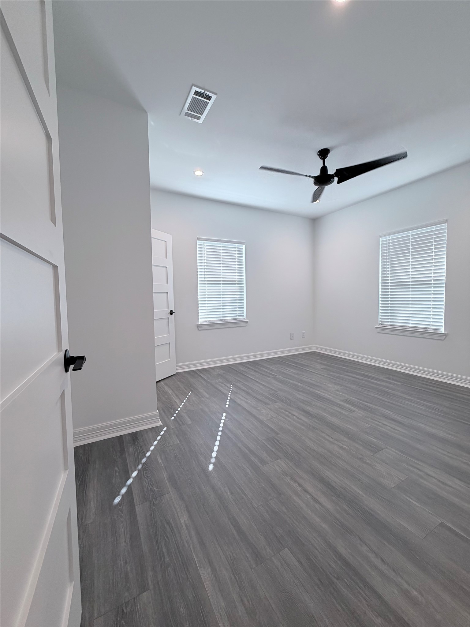 4501 Hirsch Road Houston, TX 77026 - Photo 19 of 30 an empty room with wooden floor and windows