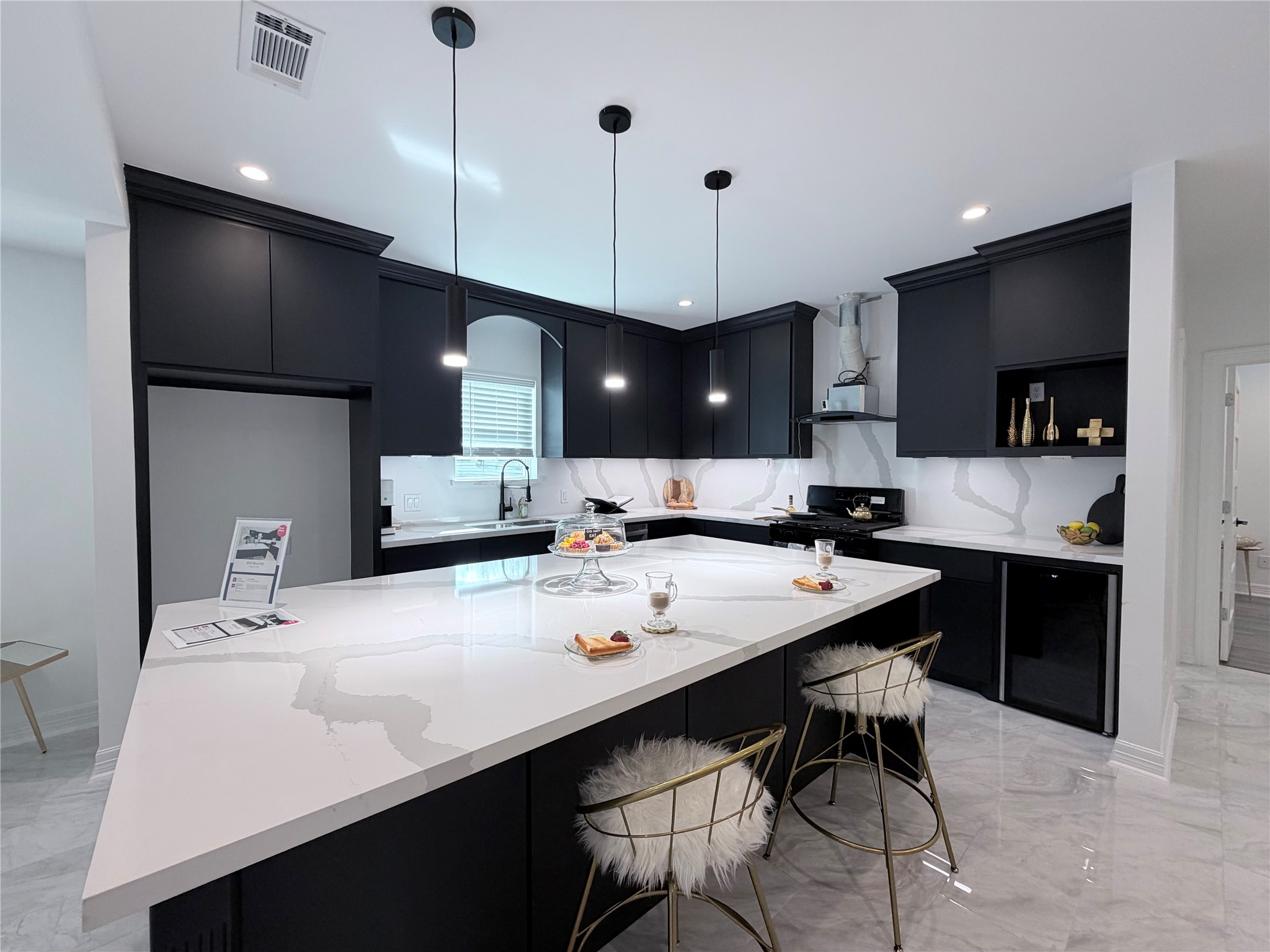 4501 Hirsch Road Houston, TX 77026 - Photo 29 of 30 a large kitchen with kitchen island a sink a counter and chairs