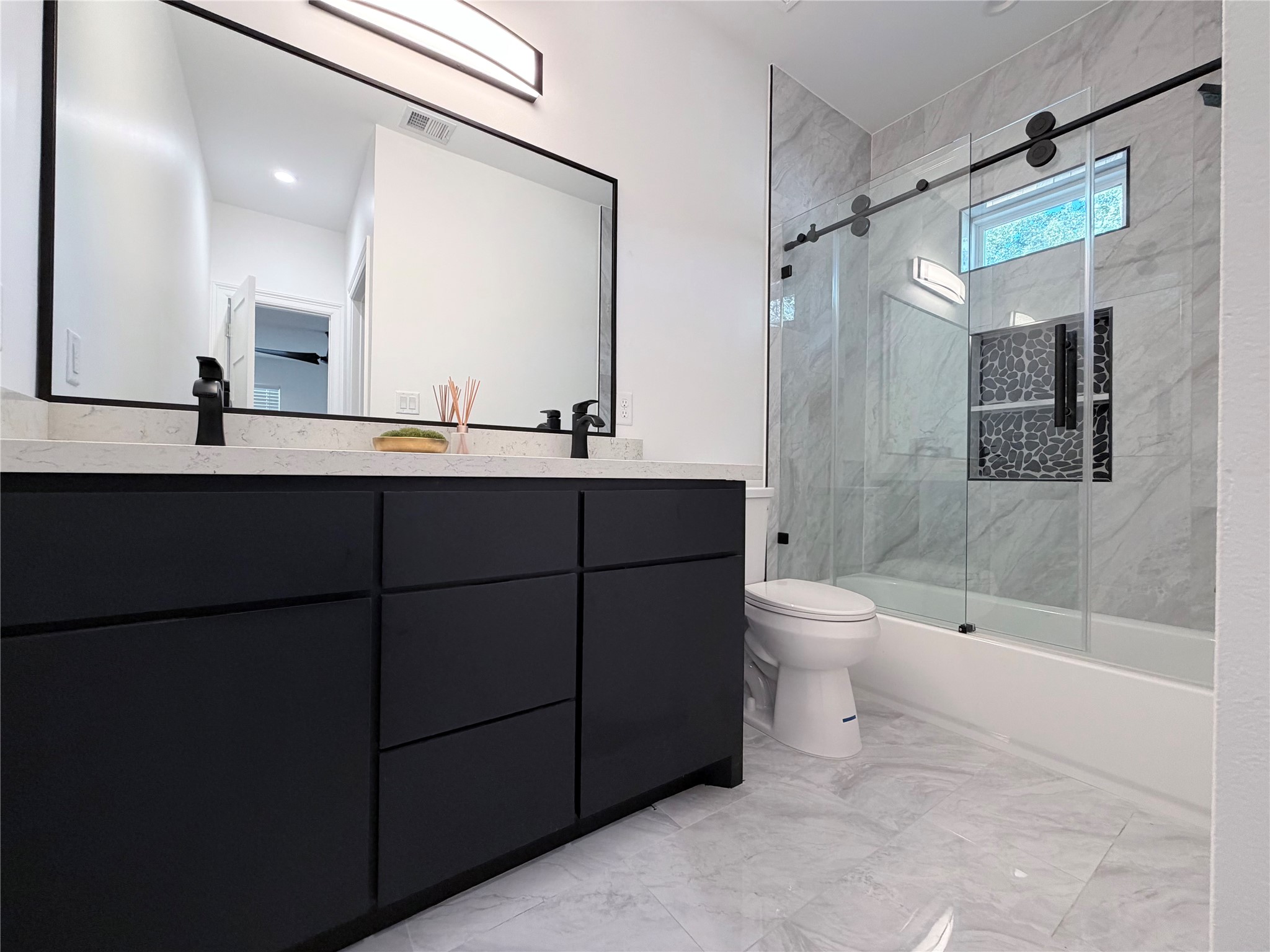 4501 Hirsch Road Houston, TX 77026 - Photo 8 of 30 a bathroom with a double vanity sink toilet mirror and shower