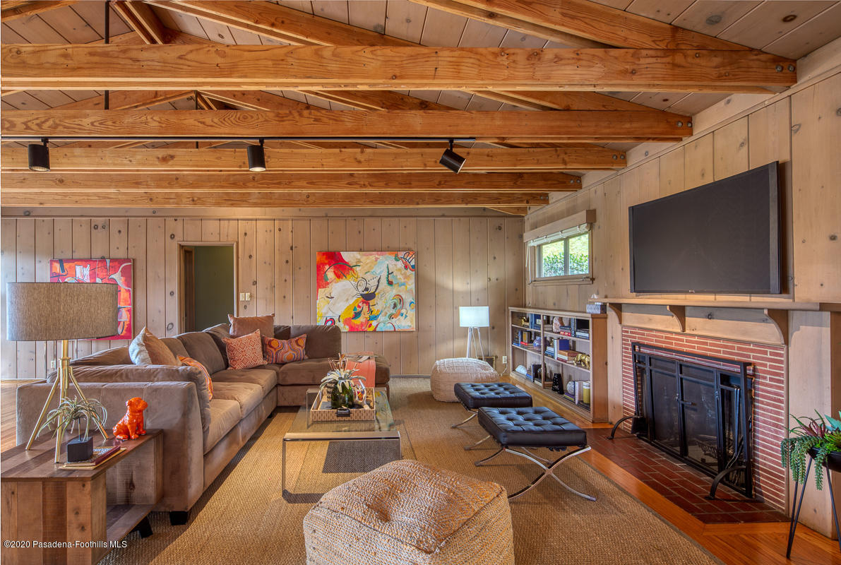 1839 North Arroyo Boulevard Pasadena, CA 91103 - Photo 2 of 36 a living room with furniture a flat screen tv and a fireplace