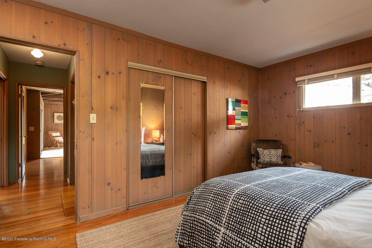 1839 North Arroyo Boulevard Pasadena, CA 91103 - Photo 20 of 36 a bedroom with a bed and wooden floor