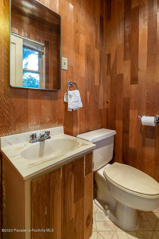 1839 North Arroyo Boulevard Pasadena, CA 91103 - Photo 21 of 36 a bathroom with a sink a toilet and mirror