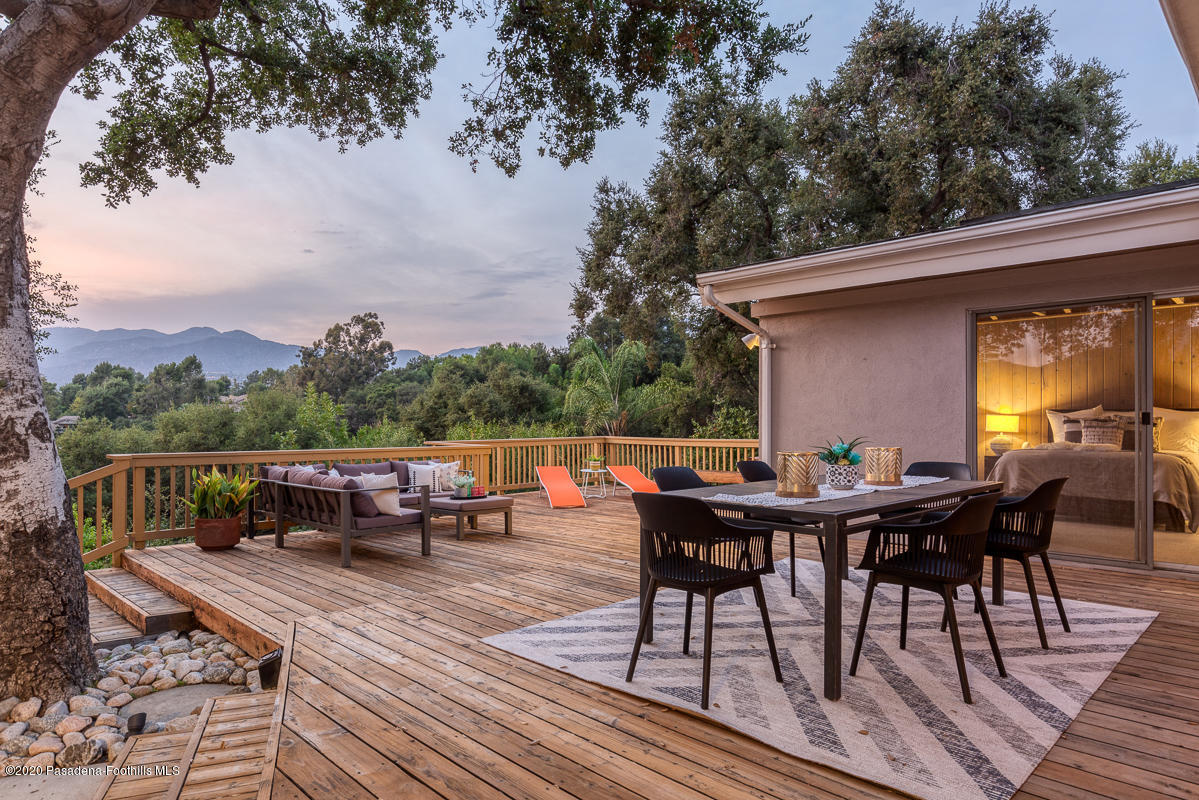 1839 North Arroyo Boulevard Pasadena, CA 91103 - Photo 22 of 36 a view of backyard with table and chairs and wooden floor