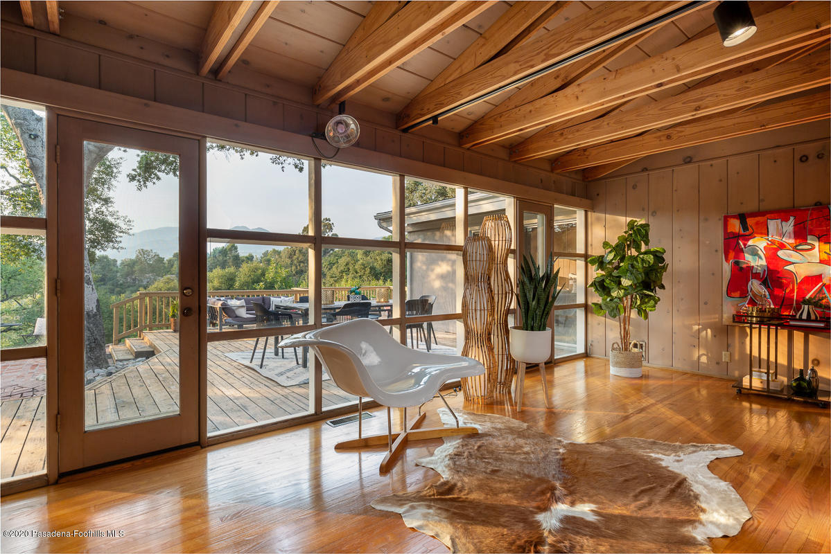 1839 North Arroyo Boulevard Pasadena, CA 91103 - Photo 5 of 36 a view of a livingroom with furniture wooden floor and a floor to ceiling window