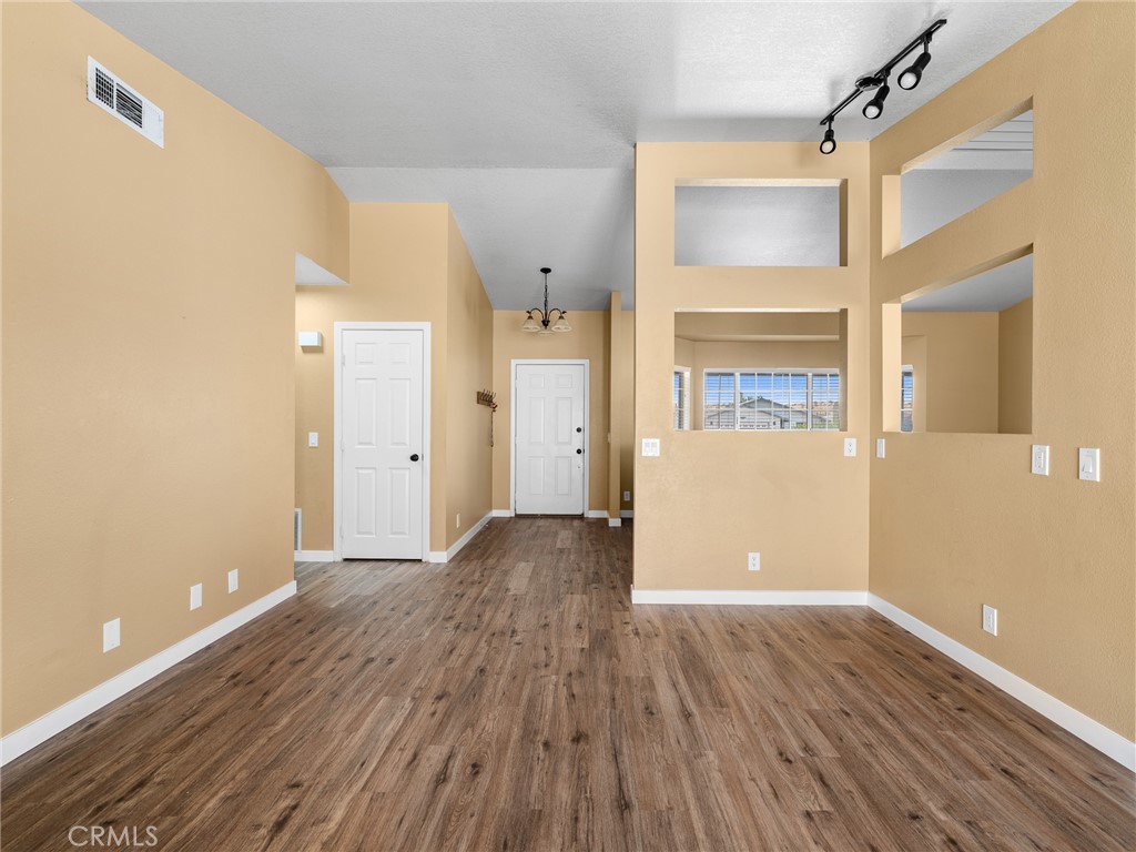 13901 Hidden Valley Road Victorville, CA 92395 - Photo 18 of 31 a view of a big room with wooden floor and windows