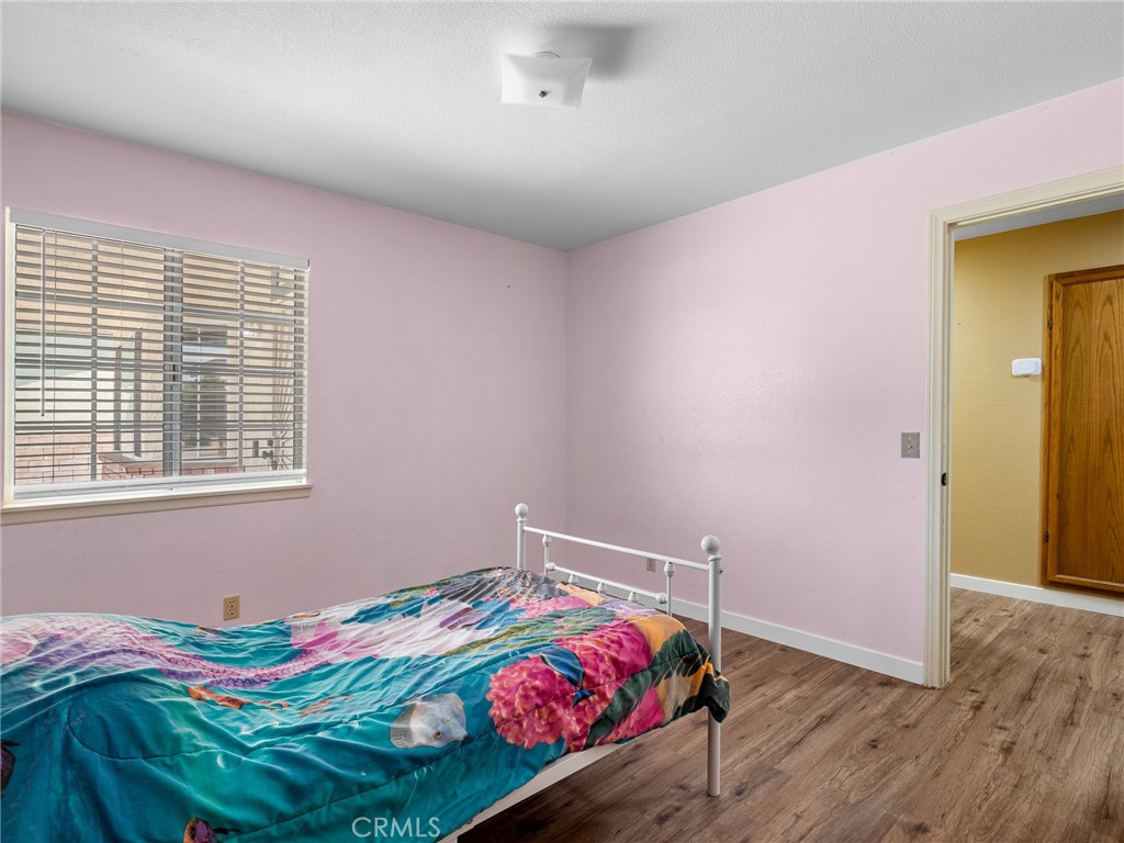 13901 Hidden Valley Road Victorville, CA 92395 - Photo 21 of 31 a bedroom with a bed and a window