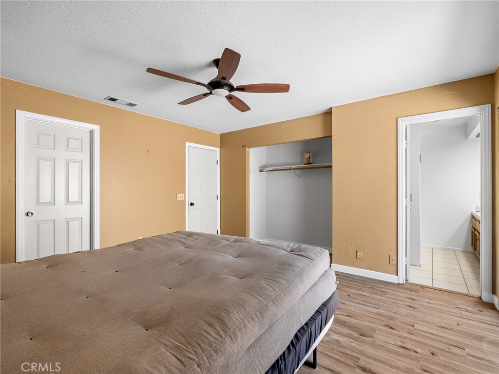 13901 Hidden Valley Road Victorville, CA 92395 - Photo 24 of 31 a bedroom with a bed and a window