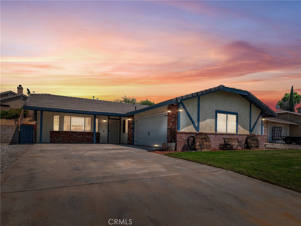13901 Hidden Valley Road Victorville, CA 92395 - Photo 4 of 31 a front view of a house with a yard and garage