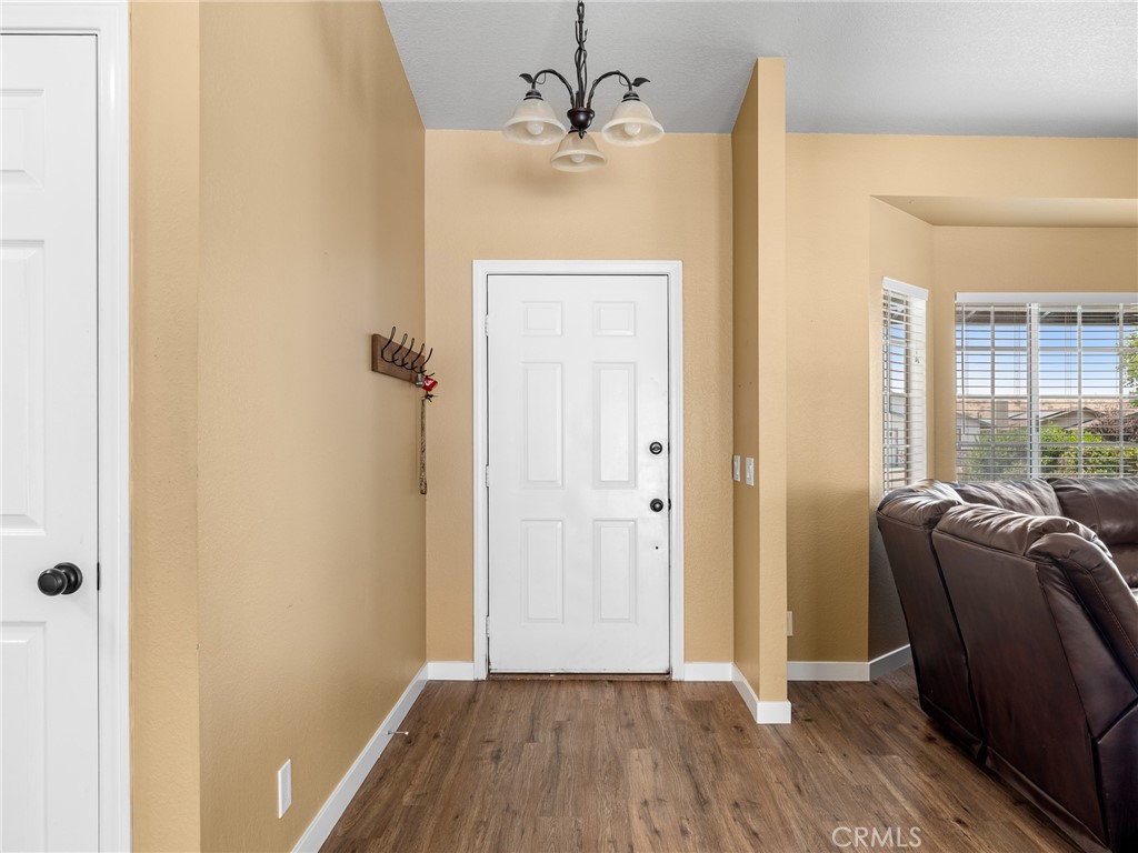 13901 Hidden Valley Road Victorville, CA 92395 - Photo 5 of 31 a view of livingroom with furniture and wooden floor