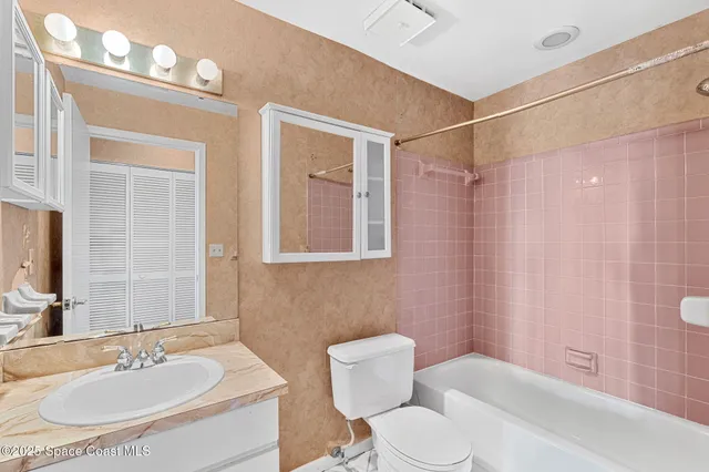 a bathroom with a sink toilet and a mirror