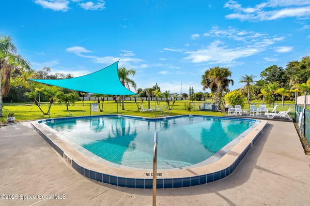 a view of a swimming pool with outdoor seating