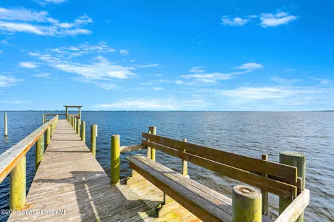 a view of a house with large trees