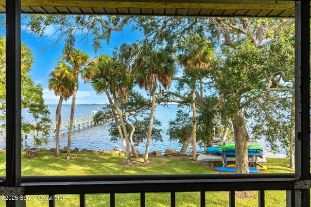a kitchen with granite countertop a sink stainless steel appliances and white cabinets
