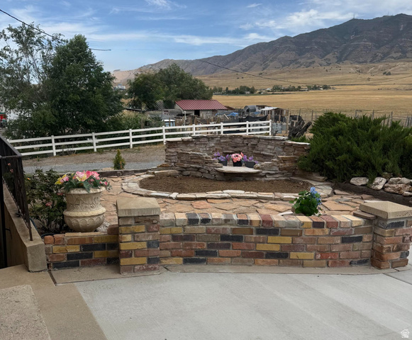 4468 North Droubay Road Tooele, UT 84074 - Photo 59 of 60 Multi-tone brick planter with stone cap, stacked stone water feature, and flagstone paving
