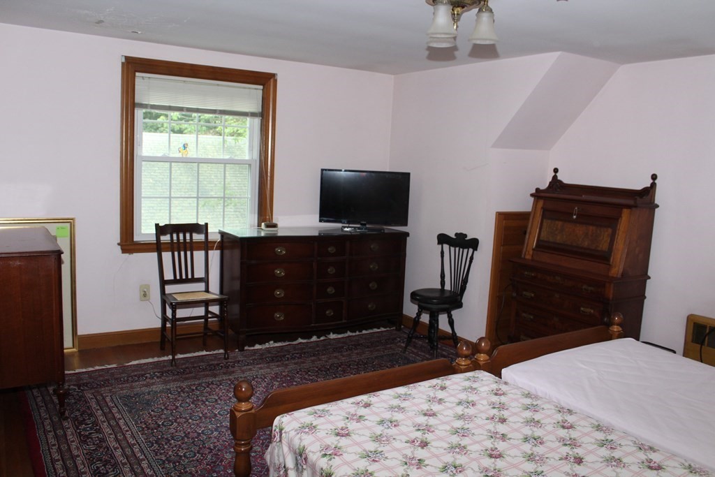 128 Webster Street Needham, MA 02494 - Photo 11 of 16 a bedroom with a bed and a television