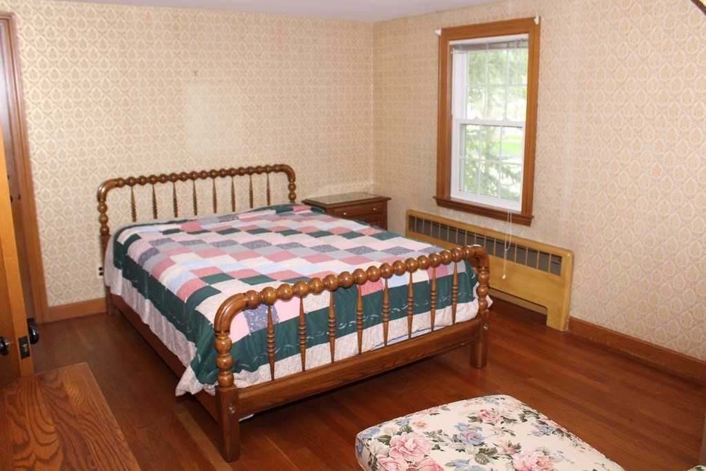 128 Webster Street Needham, MA 02494 - Photo 13 of 16 a bedroom with a bed next to a window with wooden floor