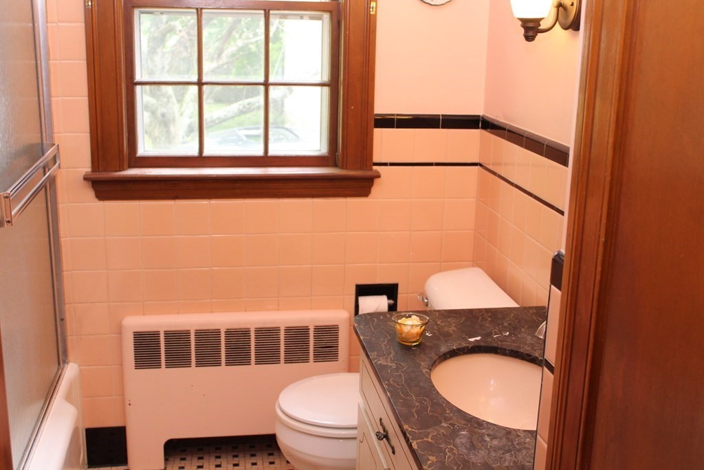 128 Webster Street Needham, MA 02494 - Photo 15 of 16 a bathroom with a granite countertop toilet a sink and a mirror