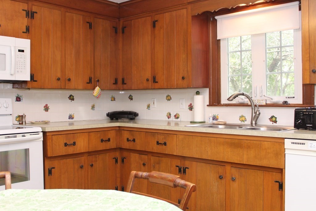 128 Webster Street Needham, MA 02494 - Photo 4 of 16 a kitchen with a sink cabinets and window