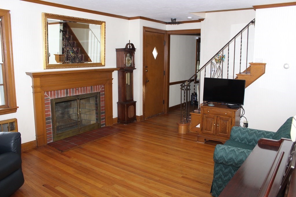 128 Webster Street Needham, MA 02494 - Photo 6 of 16 a living room with furniture a fireplace and a flat screen tv