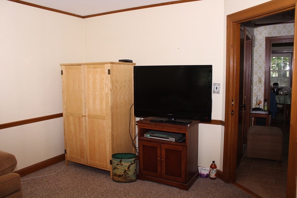 128 Webster Street Needham, MA 02494 - Photo 9 of 16 a room with furniture and a flat screen tv