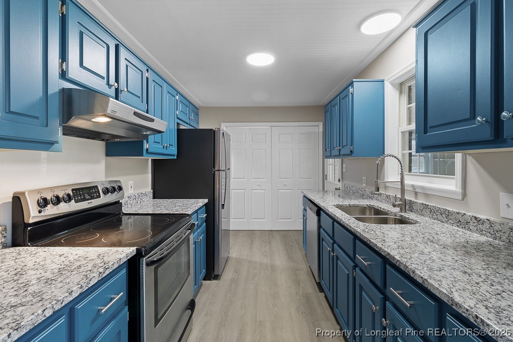 122 Spring Valley Drive Raeford, NC 28376 - Photo 12 of 36 a kitchen with granite countertop stainless steel appliances window a sink and a counter space