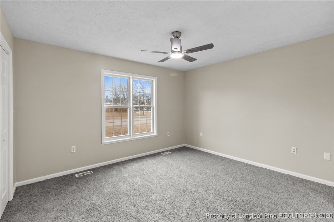 122 Spring Valley Drive Raeford, NC 28376 - Photo 16 of 36 an empty room with a window and a fan