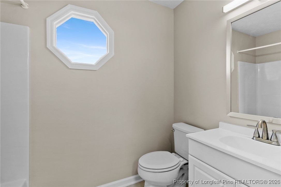 122 Spring Valley Drive Raeford, NC 28376 - Photo 25 of 36 a white toilet sitting next to a bathroom sink