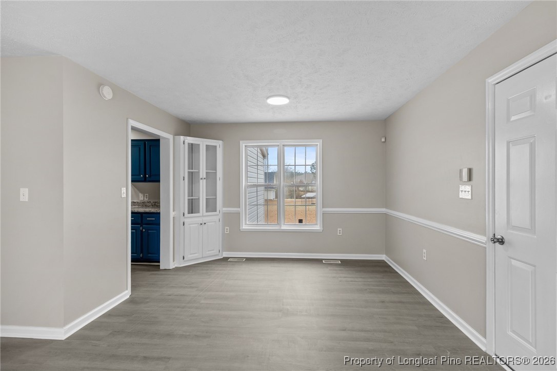 122 Spring Valley Drive Raeford, NC 28376 - Photo 8 of 36 wooden floor in an empty room with a window