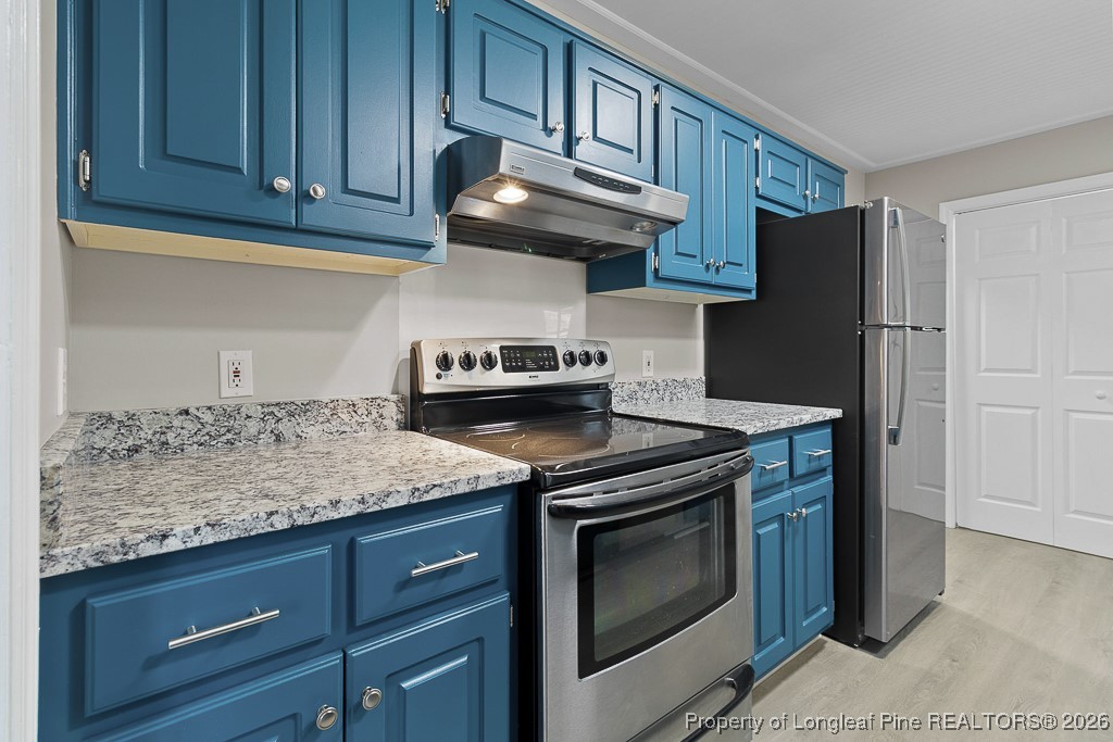122 Spring Valley Drive Raeford, NC 28376 - Photo 10 of 36 a kitchen with stainless steel appliances granite countertop cabinets and wooden floor