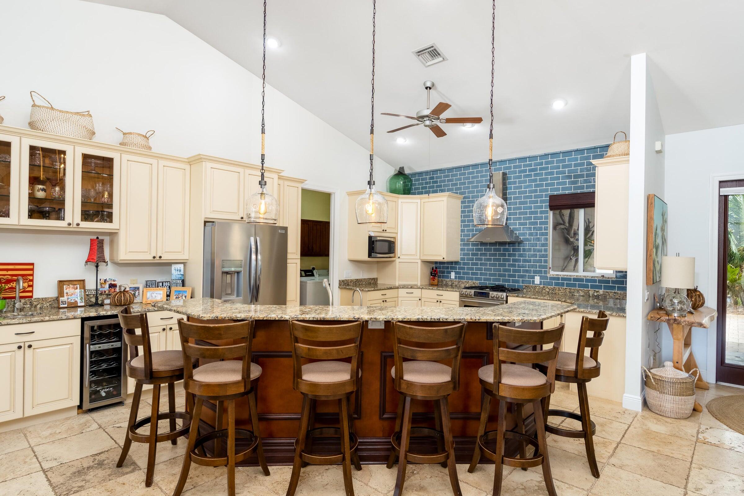 2672 Northwest S Shore Road Stuart, FL 34994 - Photo 20 of 53 a kitchen with a table chairs stove and cabinets