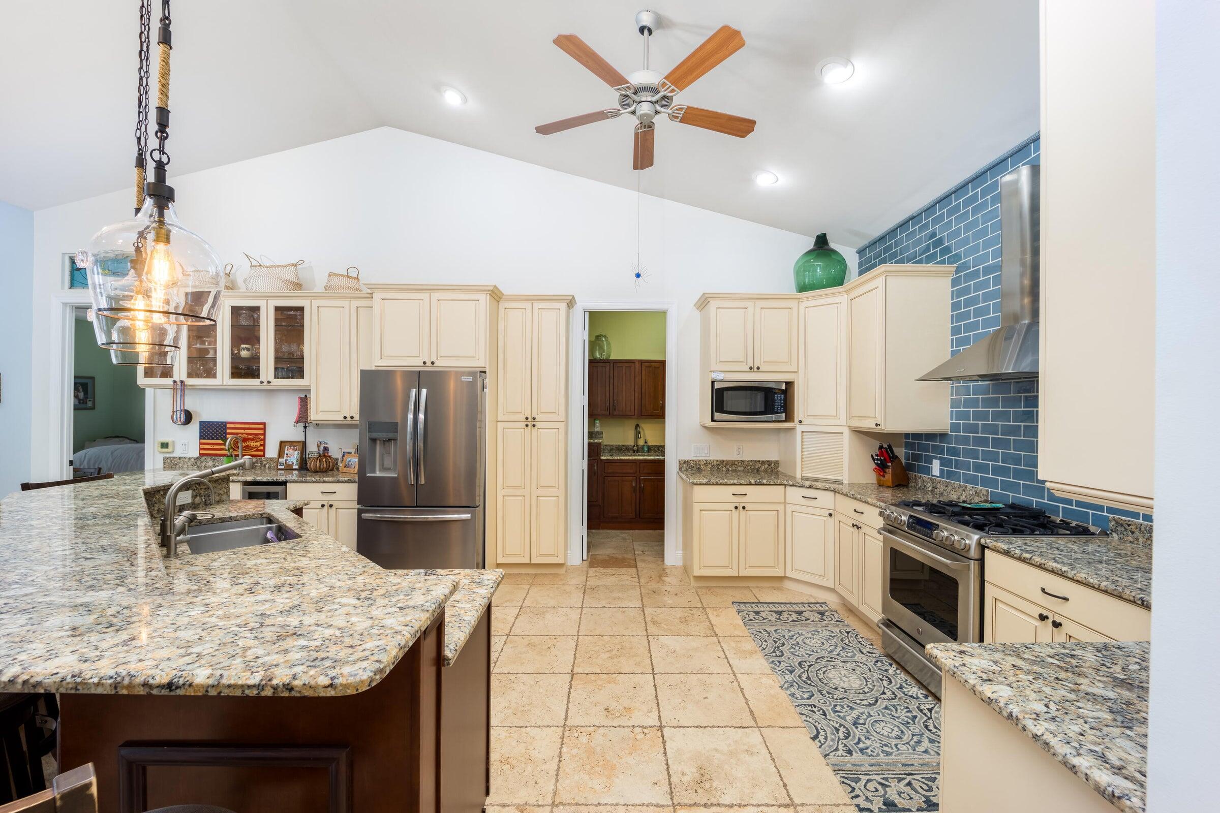 2672 Northwest S Shore Road Stuart, FL 34994 - Photo 21 of 53 a kitchen with stainless steel appliances granite countertop a stove oven and a refrigerator