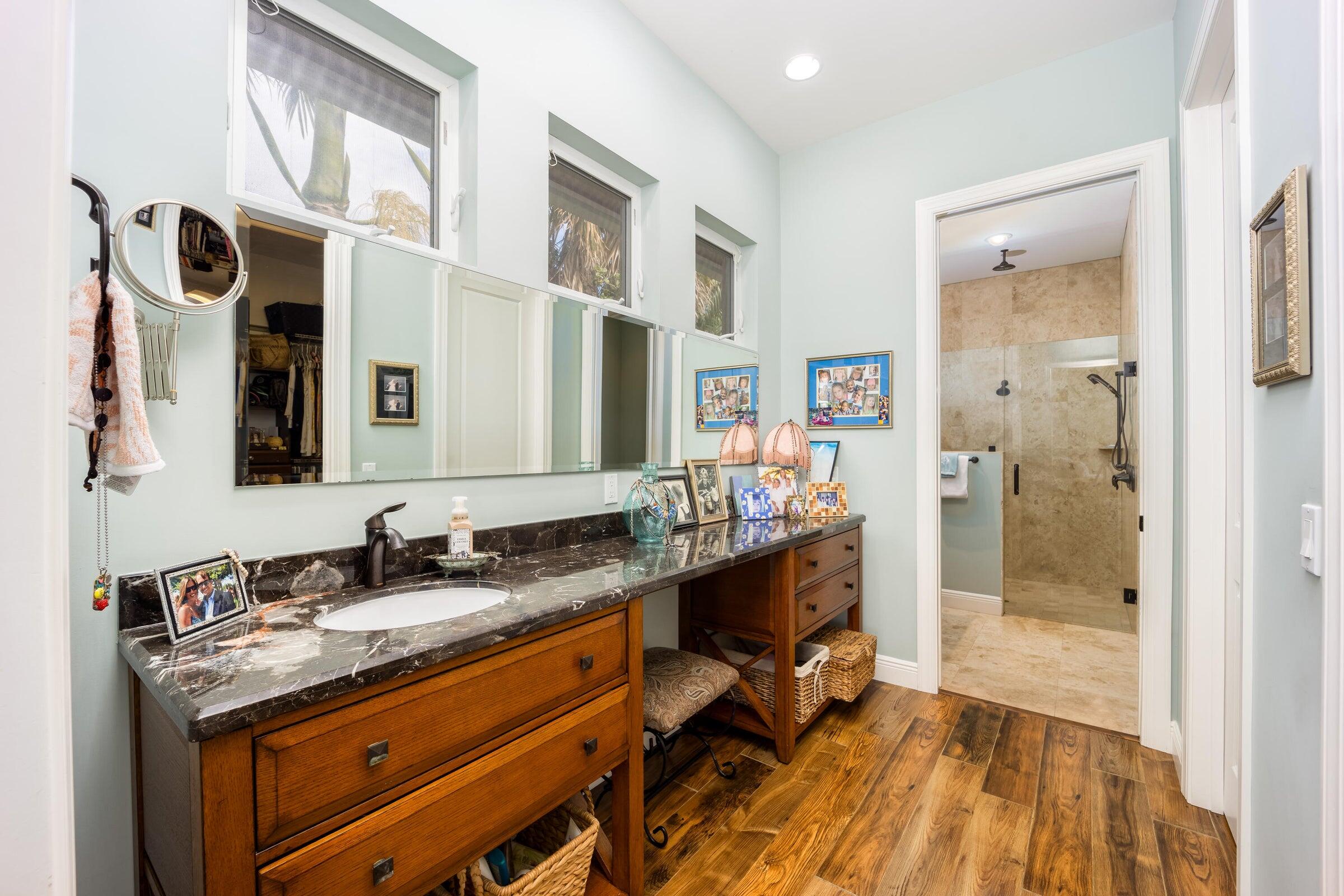 2672 Northwest S Shore Road Stuart, FL 34994 - Photo 26 of 53 a spacious bathroom with a granite countertop sink a mirror and a shower