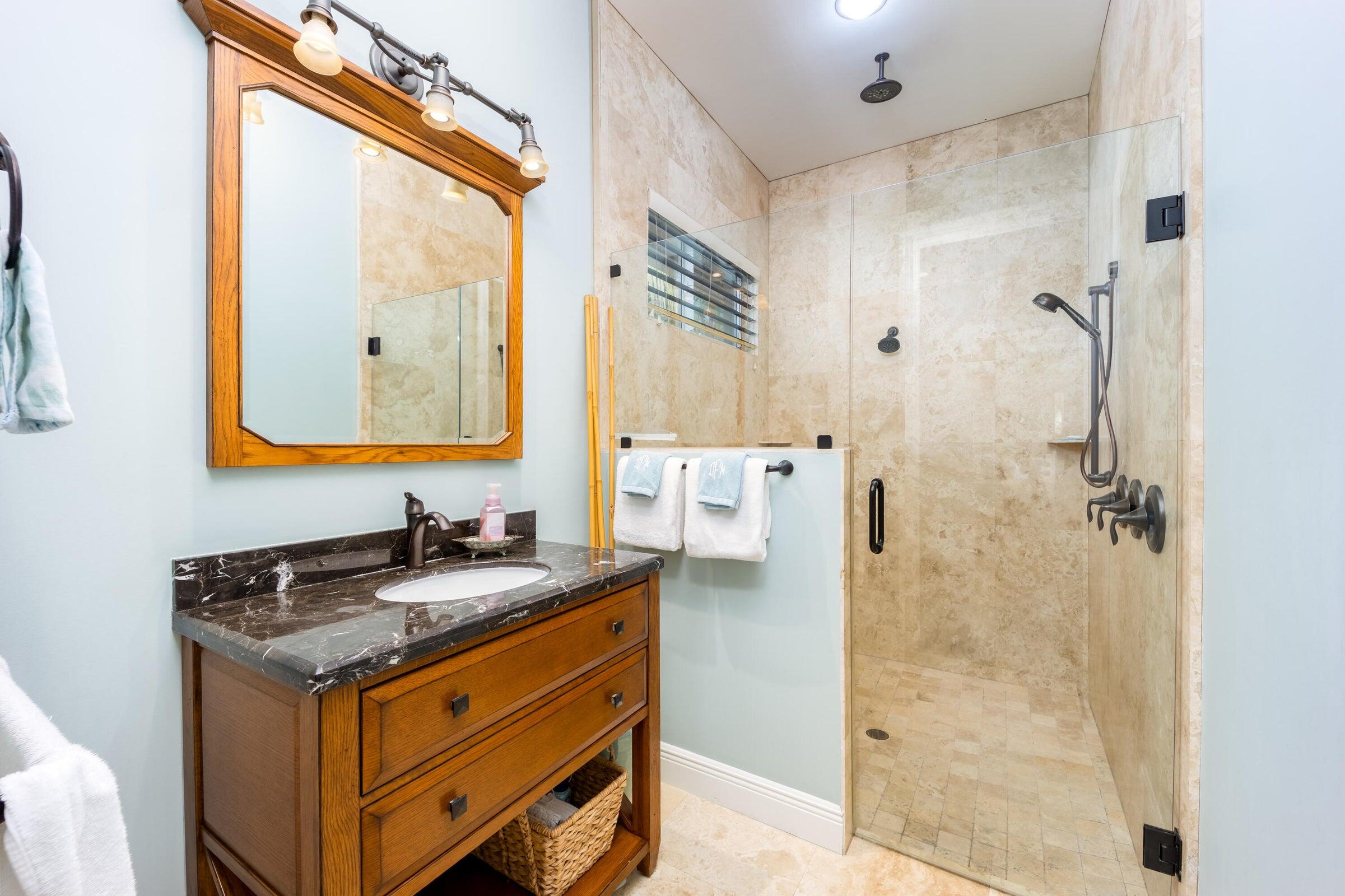 2672 Northwest S Shore Road Stuart, FL 34994 - Photo 27 of 53 a bathroom with a granite countertop sink a mirror and a shower