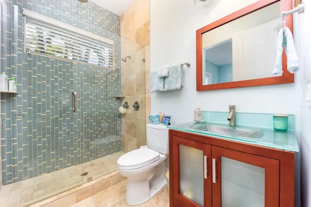 a utility room with granite countertop cabinets washer and dryer