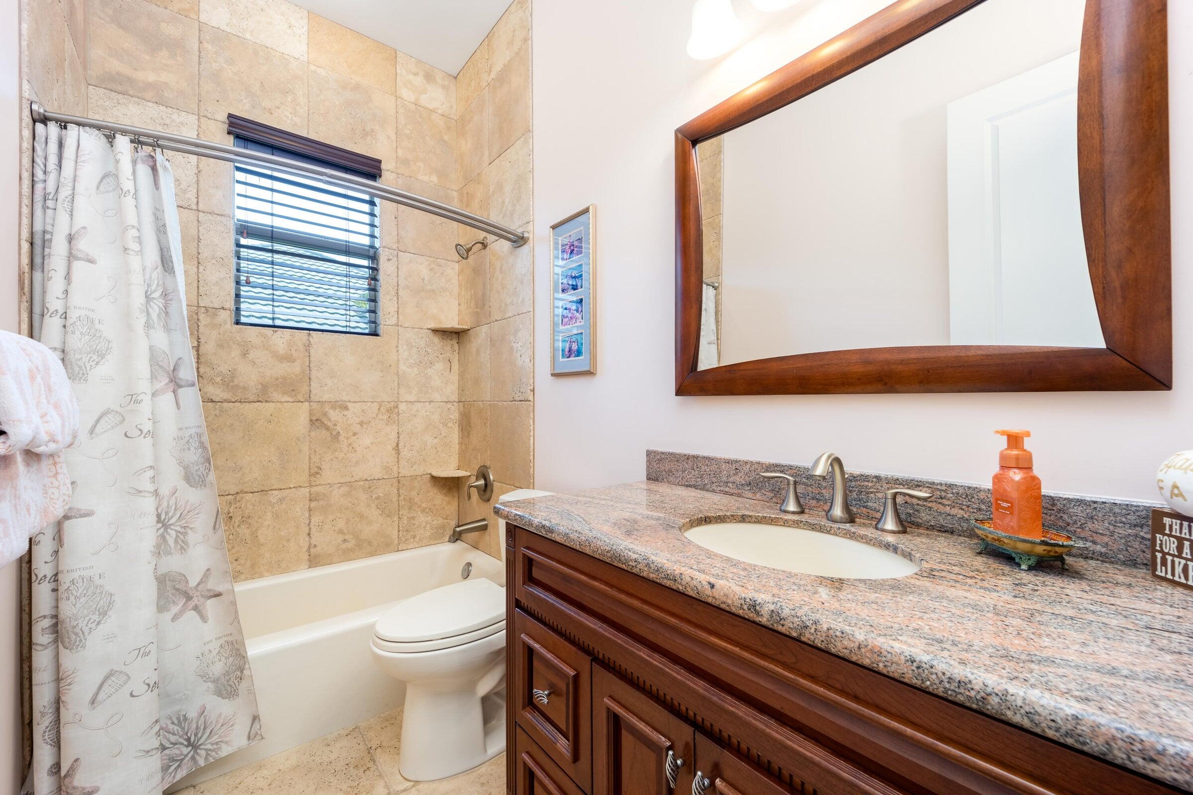 2672 Northwest S Shore Road Stuart, FL 34994 - Photo 34 of 53 a bathroom with a granite countertop sink mirror toilet and bathtub