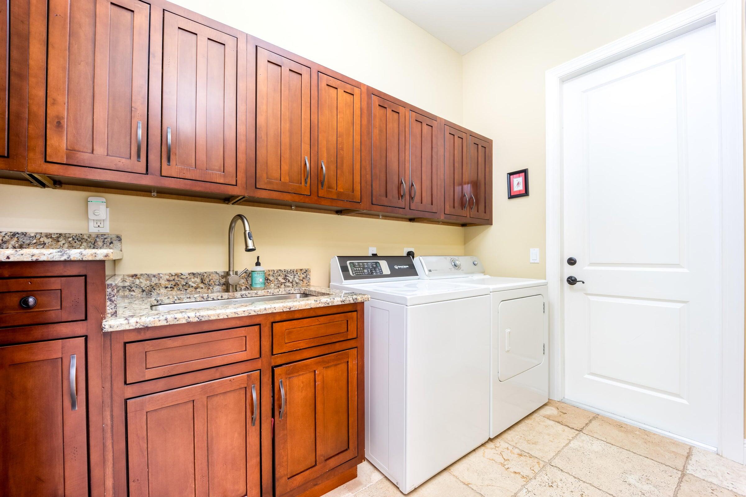 2672 Northwest S Shore Road Stuart, FL 34994 - Photo 35 of 53 a utility room with granite countertop cabinets washer and dryer