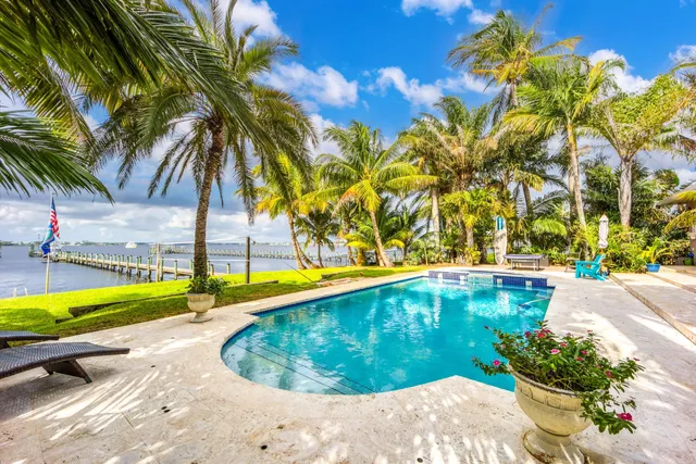 a view of a backyard with swimming pool