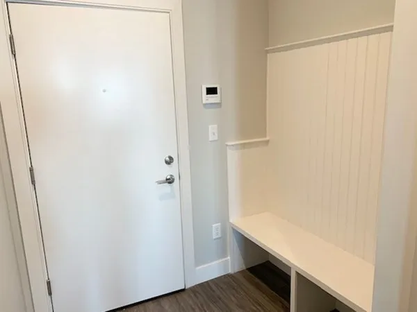 a view of a room with wooden floor