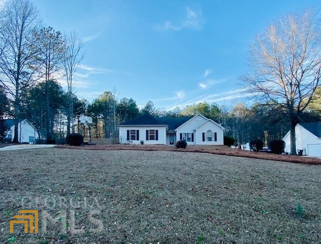 50 Riverside Way Sharpsburg, GA 30277 - Photo 1 of 1 a front view of a house with a yard and trees