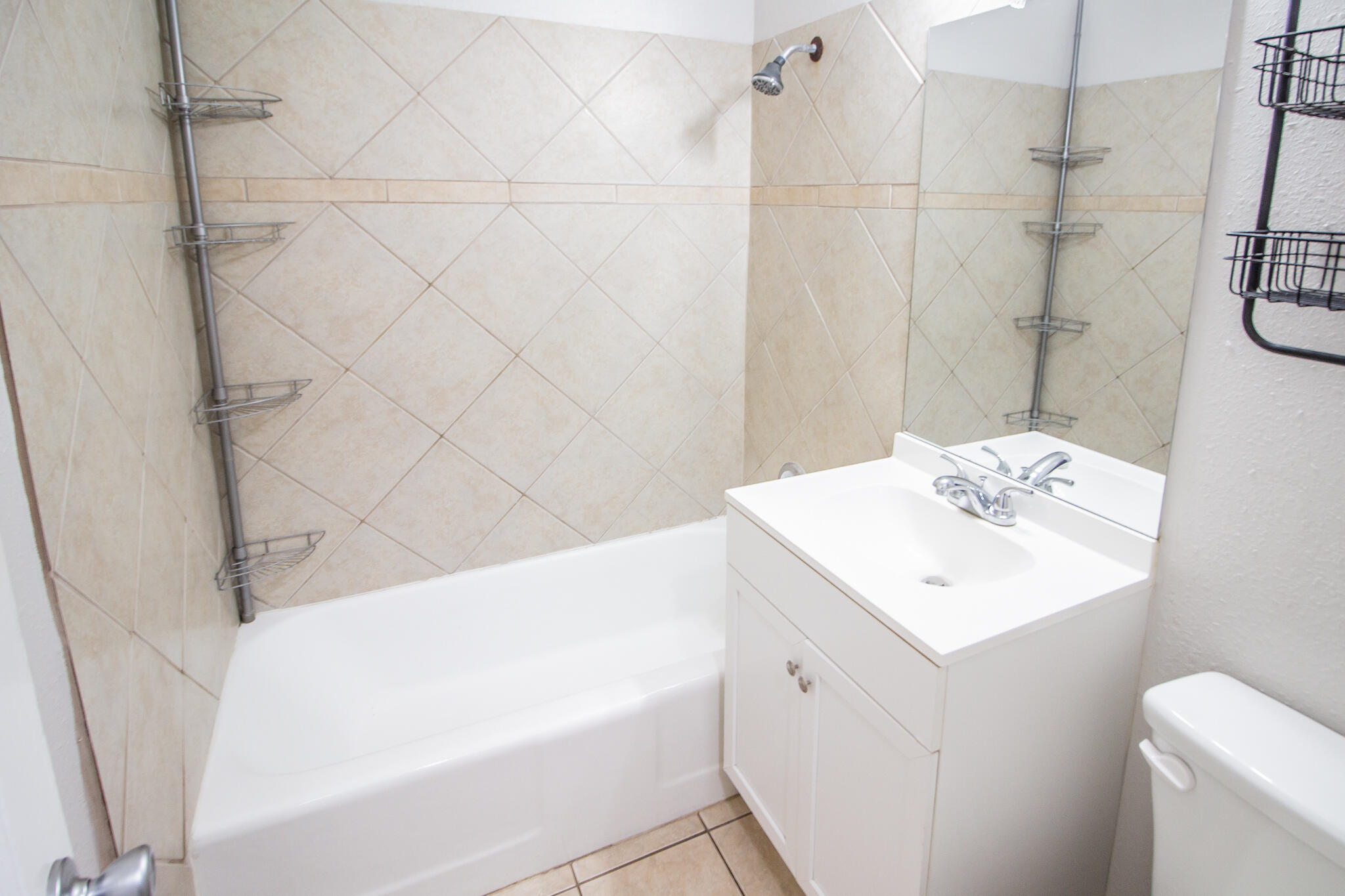 3721 31st Street Lubbock, TX 79410 - Photo 14 of 21 a bathroom with a sink a toilet and shower