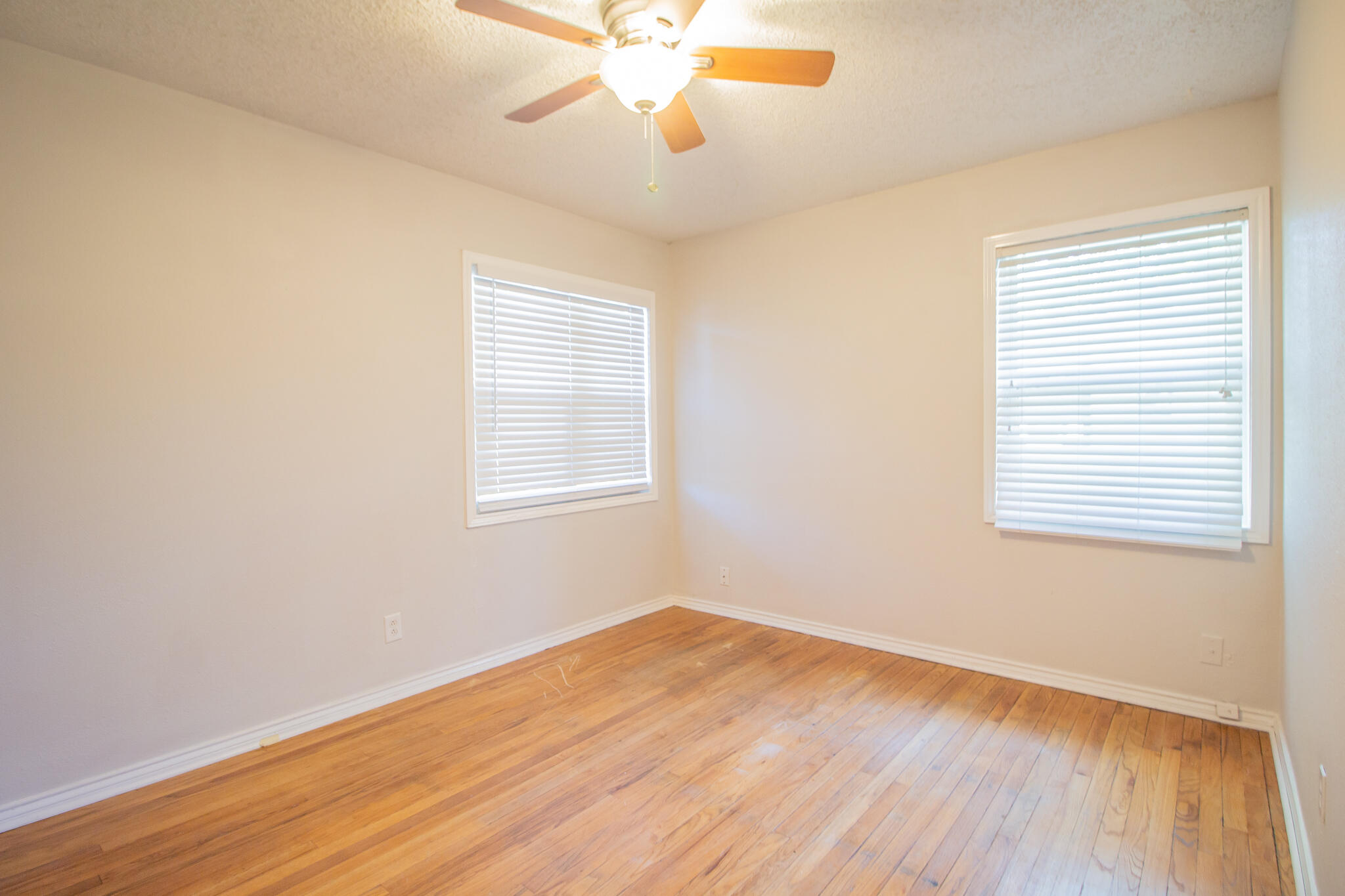 3721 31st Street Lubbock, TX 79410 - Photo 16 of 21 a view of empty room with wooden floor and fan