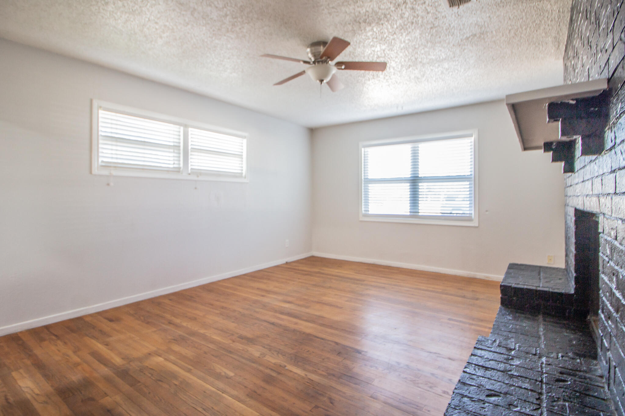 3721 31st Street Lubbock, TX 79410 - Photo 5 of 21 wooden floor in an empty room with a window